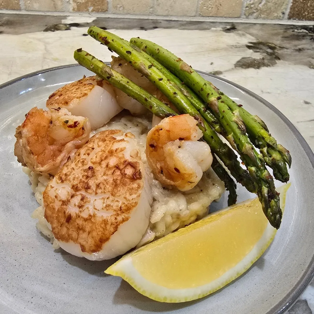 Seared scallops and shrimp with asparagus over risotto