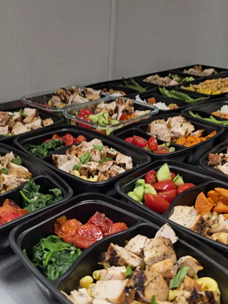 A full week of meal prep containers laid out, ready to pack