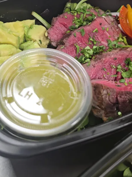 Steak salad with vinaigrette on the side