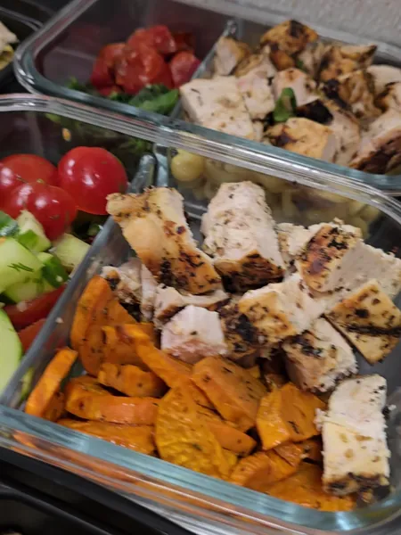 Grilled chicken and sweet potato in a glass container
