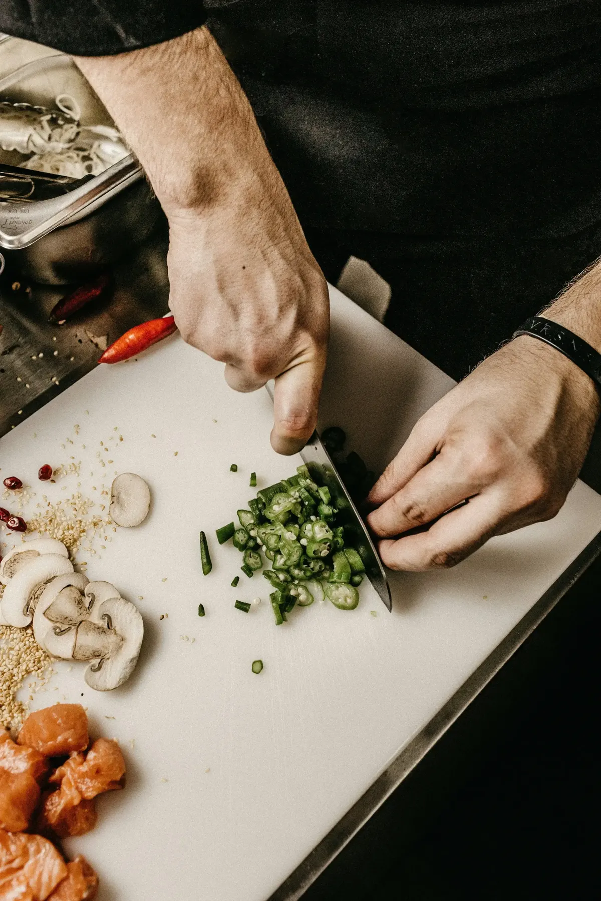 A chef slicing vegetables on a cutting board